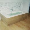 Custom cut marble in flash wall with cypress wood surround tub